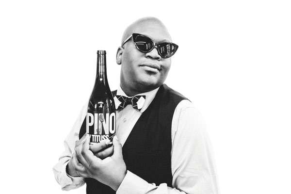 Tituss holding Pinot bottle