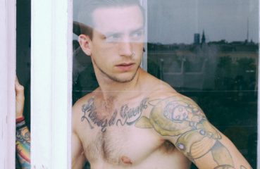 Tattooed Man in Window