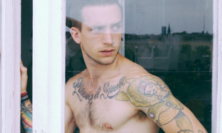 Tattooed Man in Window