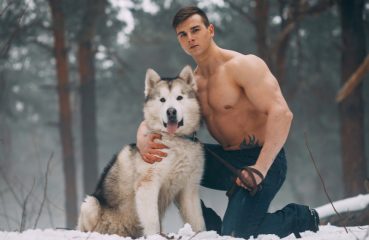muscular guy with cold weather dog
