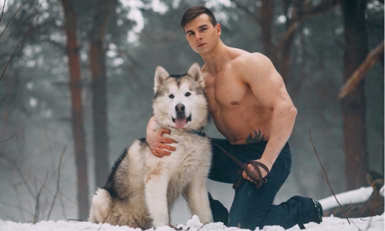 muscular guy with cold weather dog