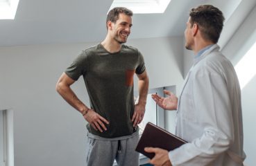 man talking with physical therapist