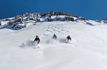 three skiiers