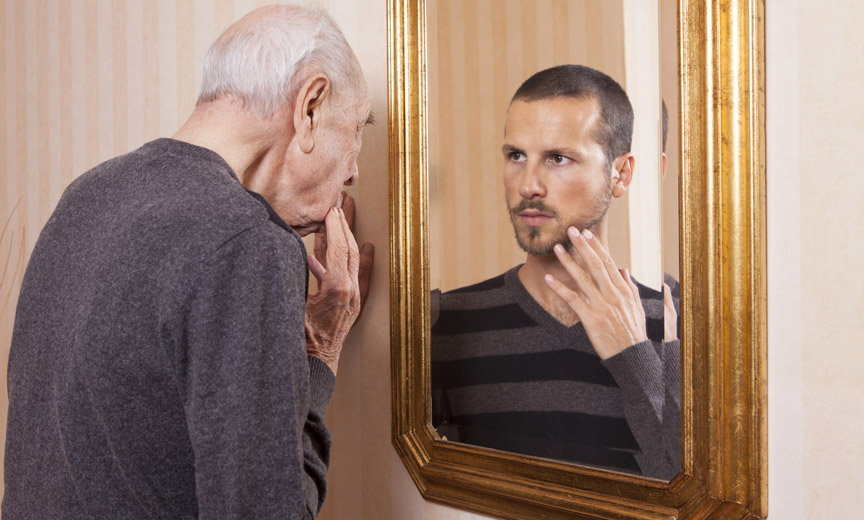Older Man Looking in Mirror at Younger Man
