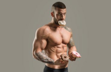 muscle guy eating donuts